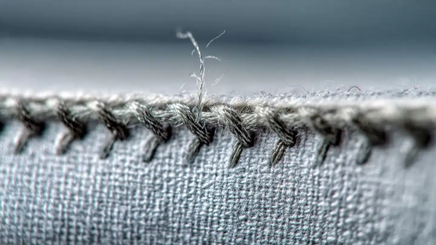Close-up of high-quality fabric stitching, highlighting durability and craftsmanship relevant to shade sails and awnings from Awnique, emphasizing long-lasting materials for outdoor solutions.